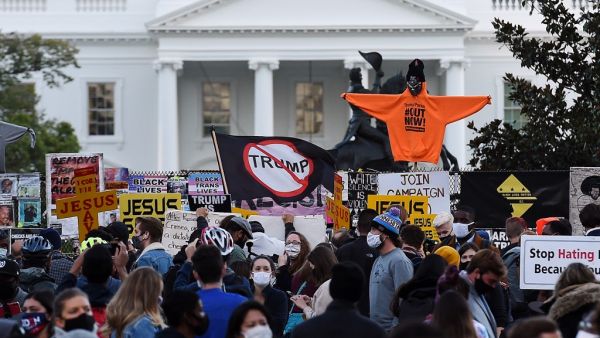 Demonstrators rally at Black Lives Matter plaza across from the White House in Washington, DC, on election day, November 3, 2020. Americans were voting on Tuesday under the shadow of a surging coronavirus pandemic to decide whether to reelect Republican Donald Trump, one of the most polarizing presidents in US history, or send Democrat Joe Biden to the White House. Olivier DOULIERY / AFP