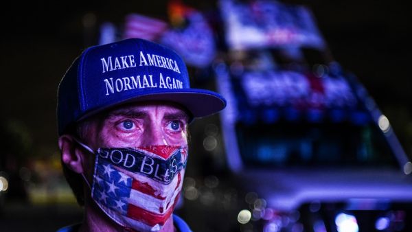 Andy Soberon a supporter of the Democratic party attends a watch party in Miami, Florida on November 3, 2020. The US is voting Tuesday in an election amounting to a referendum on Donald Trump's uniquely brash and bruising presidency, which Democratic opponent and frontrunner Joe Biden urged Americans to end to restore "our democracy." CHANDAN KHANNA / AFP