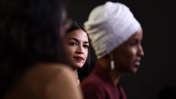 In this file photo taken on July 15, 2019 US Representatives Ilhan Omar (D-MN) speaks as Alexandria Ocasio-Cortez (D-NY) (C) looks on during a press conference, to address remarks made by US President Donald Trump earlier in the day, at the US Capitol in Washington, DC. New York progressive Alexandria Ocasio-Cortez comfortably secured a second term in Congress on November 3, 2020 with an expected win over her Republican challenger who was outspent despite raising $10 million. Ocasio-Cortez is part of a quar
