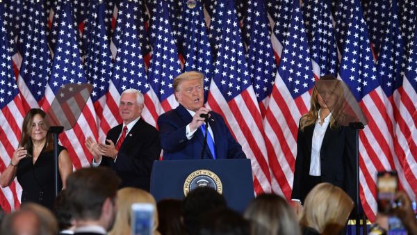 US President Donald Trump arrives to speak, flanked by Karen Pence, US Vice President Mike Pence and US First Lady Melania Trump. during election night in the East Room of the White House in Washington, DC, early on November 4, 2020. MANDEL NGAN / AFP