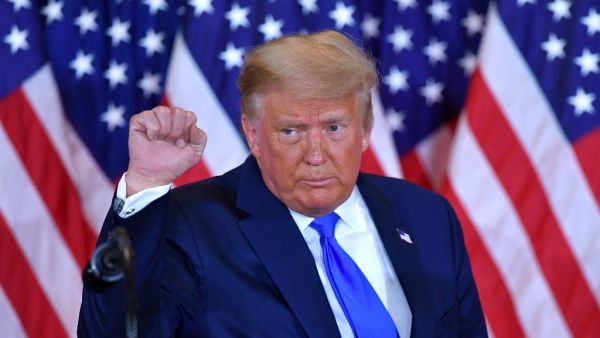 US President Donald Trump pumps his fist after speaking during election night in the East Room of the White House in Washington, DC, early on November 4, 2020. MANDEL NGAN / AFP