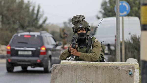 Israeli soldiers gather at a checkpoint near Nablus in the occupied West Bank where a Palestinian who shot at Israeli troops on November 4, 2020 was killed when soldiers returned fire, Israel's army said. JAAFAR ASHTIYEH / AFP