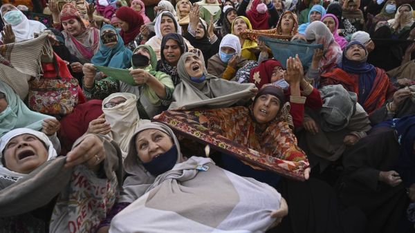 Muslim devotees react as a priest displays a relic believed to be a hair from the beard of Prophet Mohammed during the last Friday of Eid Milad-un-Nabi, which marks the birth anniversary of the Prophet, at the Hazratbal Shrine in Srinagar on November 6, 2020. TAUSEEF MUSTAFA / AFP