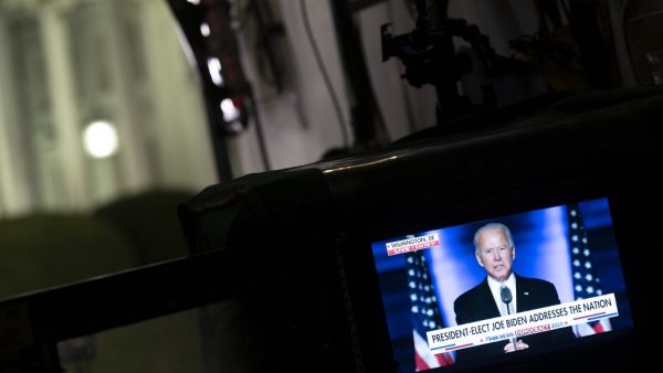 A screen shows US President-elect Joe Biden delivering remarks in Wilmington, on a monitor near the White House on November 7, 2020 in Washington, DC. Democrat Joe Biden urged unity on November 7 and promised "a new day for America" in his first national address since he won the tense US election and ended the historically turbulent and divisive era of Donald Trump. ANDREW CABALLERO-REYNOLDS / AFP