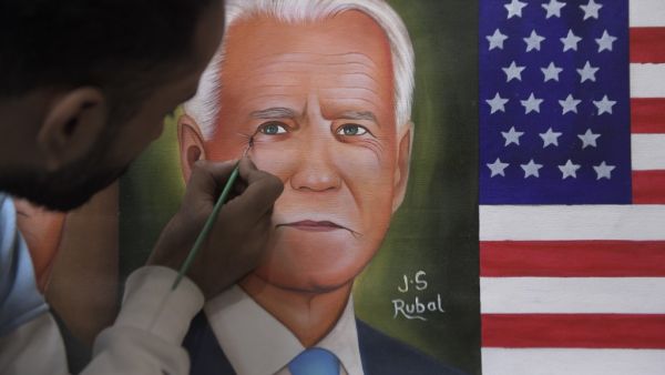 A painter gives the final touches to a painting depicting newly elected US President Joe Biden, in Amritsar on November 8, 2020. NARINDER NANU / AFP