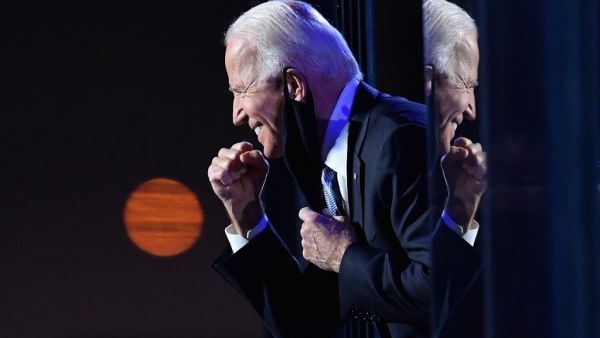 US President-elect Joe Biden gestures to the crowd after he delivered remarks in Wilmington, Delaware, on November 7, 2020. Democrat Joe Biden was declared winner of the US presidency November 7, defeating Donald Trump and ending an era that convulsed American politics, shocked the world and left the United States more divided than at any time in decades. Angela Weiss / AFP