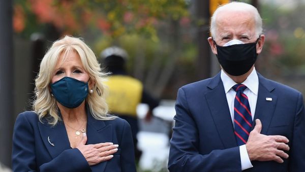 US President-elect Joe Biden and his wife Jill Biden pay their respects during a Veterans Day stop at the Korean War Memorial Park in Philadelphia, Pennsylvania on November 11, 2020. The leaders of close US allies on November 10, 2020 telephoned President-elect Joe Biden and pledged to work together but in an extraordinary break, America's top diplomat Mike Pompeo insisted that Donald Trump would remain in power. The transition team said Biden planned to work with the Europeans on fighting the Covid-19 pand