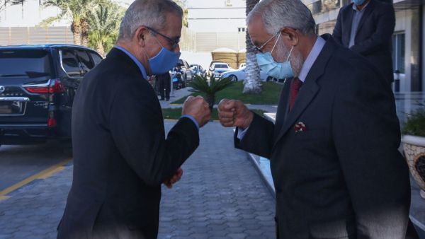 Foreign Minister of Libya's UN-recognised Government of National Accord (GNA) Mohamed Taha Siala (R) and his Maltese counterpart Evarist Bartolo bump fists ahead of a meeting in the capital Tripoli, on November 16, 2020. AFP