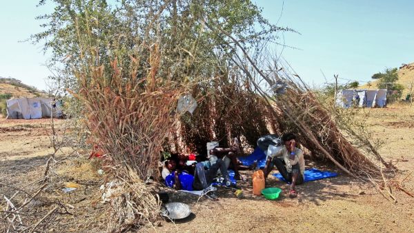 Ethiopian refugees who fled fighting in Tigray province lay in the shade in a straw shack at the Um Rakuba camp in Sudan's eastern Gedaref province, on November 18, 2020. Sudan -- one of the world's poorest countries, now faced with the massive influx -- has reopened the camp, 80 kilometres (50 miles) from the border. It once housed refugees who fled Ethiopia's 1983-85 famine that killed over a million people. Ebrahim HAMID / AFP