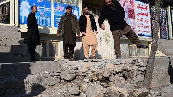 Residents gather at a site after several rockets land at Khair Khana, north west of Kabul on November 21, 2020. A series of loud explosions shook central Kabul on November 21, including several rockets that landed near the heavily fortified Green Zone where many embassies and international firms are based, officials said. WAKIL KOHSAR / AFP