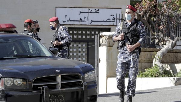 Policemen stand guard outside a detention centre from which prisoners had fled earlier in Baabda, east of Lebanon's capital Beirut, on November 21, 2020. At least 69 people fled a detention centre in Lebanon on November 21, including five who later died in a car accident on a nearby road, sparking a wide-reaching manhunt, police said. ANWAR AMRO / AFP