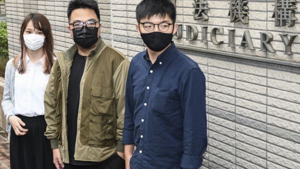 Pro-democracy activists (L-R) Agnes Chow, Ivan Lam and Joshua Wong arrive for their trial at West Kowloon Magistrates Court in Hong Kong on November 23, 2020, on unauthorised assembly charges in relation to protests in 2019. Peter PARKS / AFP