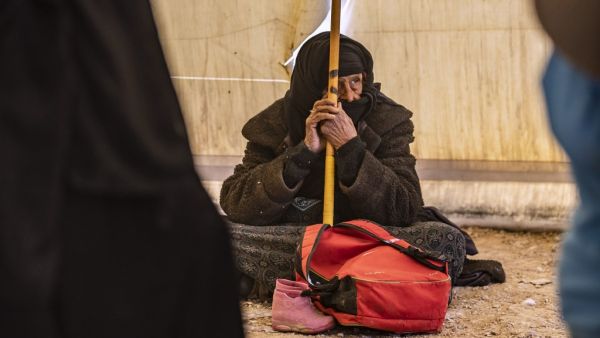 An elderly Syrian woman waits to leave the Kurdish-run al-Hol camp holding relatives of alleged Islamic State (IS) group fighters, in the al-Hasakeh governorate in northeastern Syria, on November 24, 2020. AFP