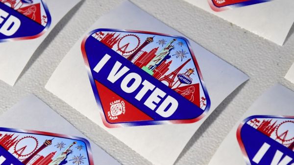  Las Vegas Strip-themed "I Voted" stickers are placed on a table where voters turn in their activation cards after voting inside a tent at a shopping center parking lot on November 3, 2020 in North Las Vegas, Nevada. Ethan Miller / GETTY IMAGES NORTH AMERICA / Getty Images via AFP