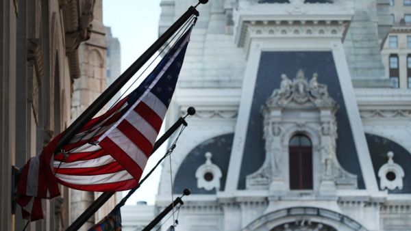 An American Flag hangs from a building in Philadelphia the morning after Americans voted in the presidential election on November 04, 2020 in Philadelphia, Pennsylvania. With no winner declared in the presidential election last night, all eyes are on the outcome in a few remaining swing states to determine whether Donald Trump will get another four years or if Joe Biden will become the next president of the United States. The counting of ballots in Pennsylvania continued through the night with no winner yet