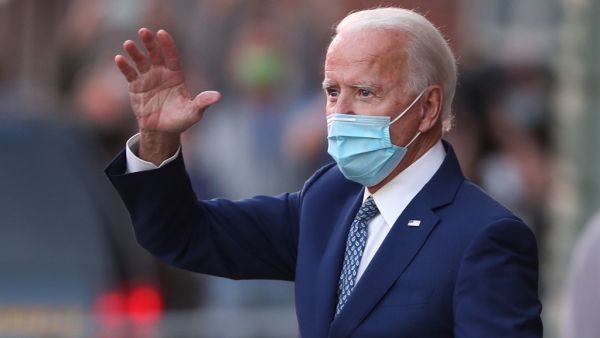 President-elect Joe Biden waves to supporters as he leaves the Queen theater after receiving a briefing from the transition COVID-19 advisory board on November 09, 2020 in Wilmington, Delaware. Mr. Biden addressed the media earlier in the day about his response to the COVID-19 pandemic. Joe Raedle/Getty Images/AFP JOE RAEDLE / GETTY IMAGES NORTH AMERICA / Getty Images via AFP