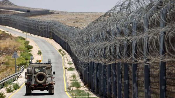 An Israeli army vehicle is seen driving along the road along the border fence separating the Israeli-annexed Golan Heights and Syria, on July 19, 2017. Photo by MENAHEM KAHANA/AFP via Getty Images.  Read more: https://www.al-monitor.com/pulse/originals/2020/08/israel-iran-syria-lebanon-hezbollah-golan-heights-undof-idf.html#ixzz6fC7zHOns