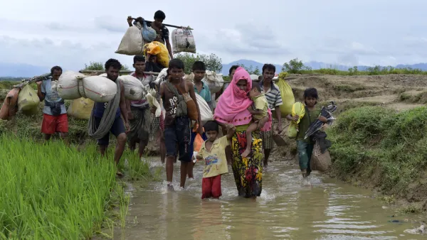 Members of Myanmar's Muslim Rohingya minority walk through a broken road at Kanjir para, at Teknaf in Cox's Bazer, Bangladesh. (Shutterstock/ File Photo)