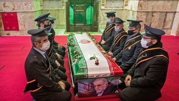 Members of Iranian forces pray around the coffin of slain nuclear scientist Mohsen Fakhrizadeh during the burial ceremony at Imamzadeh Saleh shrine in northern Tehran, on November 30, 2020.HAMED MALEKPOUR / TASNIM NEWS / AFP
