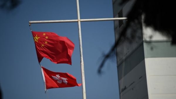 The Chinese (top) and Hong Kong flags flutter in Hong Kong on December 5, 2020. PETER PARKS / AFP