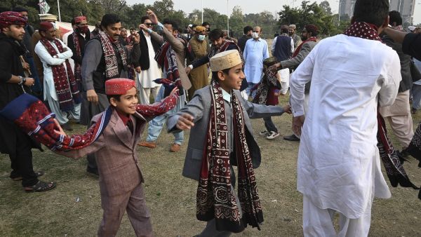 People wearing traditional dresses dance to celebrate the Sindhi Cultural Day in Islamabad on December 6, 2020. Aamir QURESHI / AFP