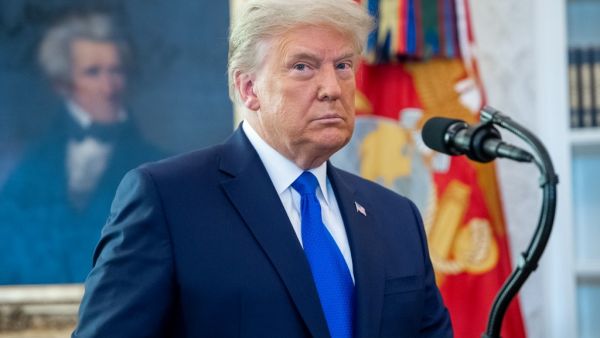 US President Donald Trump looks on during a ceremony presenting the Presidential Medal of Freedom to wrestler Dan Gable in the Oval Office of the White House in Washington, DC on December 7, 2020. SAUL LOEB / AFP