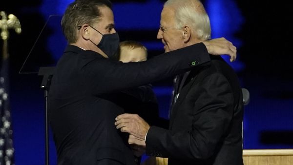 US President-elect Joe Biden (R) embraces his son Hunter Biden (L) on stage after delivering remarks in Wilmington, Delaware. US President-elect Joe Biden's son Hunter, a frequent target of Republican attacks during the 2020 election campaign, said December 9, 2020, he is under investigation for potential tax violations. Andrew Harnik / POOL / AFP