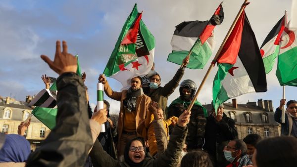 Supporters of Western Sahara's independence hold Western Sahara and Algerian flags during a demonstration, in Bordeaux, southwestern France on December 12, 2020. Algeria, Morocco's neighbour and regional rival, is the key foreign backer of the Polisario Front, which has campaigned for independence for Western Sahara since the 1970s. thibaud MORITZ / AFP