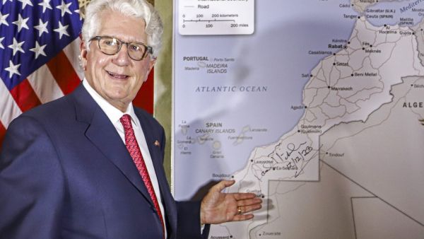 David T. Fischer, US Ambassador to the Kingdom of Morocco, standing before a US State Department-authorised map of Morocco recognising the internationally-disputed territory of the Western Sahara (bearing a signature by Fischer) as a part of the North African kingdom, in Morocco's capital Rabat on December 12, 2020. AFP
