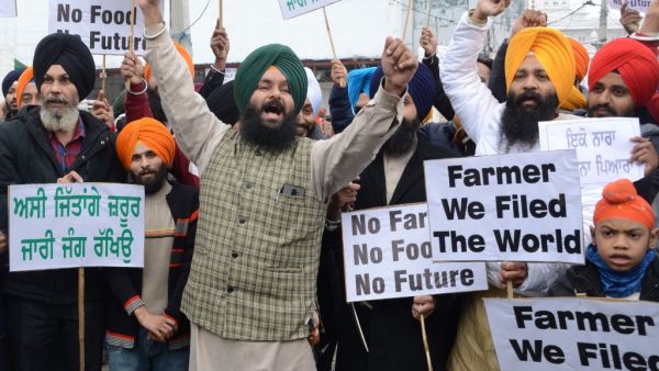 Protesters hold placards and shout slogans against Indian Prime Minister Narendra Modi during a protest rally in support of farmers against the recent agricultural reforms, in Amritsar on December 13, 2020. Narinder NANU / AFP
