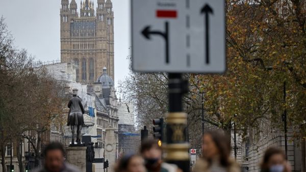 Pedestrians walk away from the Palace of Westminster in central London on December 13, 2020, as the leaders of Britain and the European Union agree to contine talks beyond the latest deadline. Sunday is just the latest in a string of supposedly hard deadlines for the negotiations but, with Britain due to leave the EU single market in 19 days, tensions are rising. Tolga Akmen / AFP