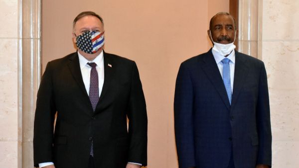 In this file photo taken on August 25, 2020, US Secretary of State Mike Pompeo (L) poses for a picture with Sudan's Sovereign Council chief General Abdel Fattah al-Burhan in Khartoum. The United States on December 14, 2020 formally removed Sudan's state sponsor of terrorism designation, 27 years after putting the country on its blacklist, the US embassy in Khartoum announced. "The congressional notification period of 45 days has lapsed and the Secretary of State has signed a notification stating rescission 