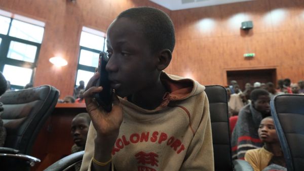 A child speaks on the phone while gathering at the Government House with other students from the Government Science Secondary school, in Kankara, in northwestern Katsina State, Nigeria upon their release on December 18, 2020. More than 300 Nigerian schoolboys were released on Thursday after being abducted in an attack claimed by Boko Haram, officials said, although it was unclear if any more remained with their captors Kola SULAIMON / AFP