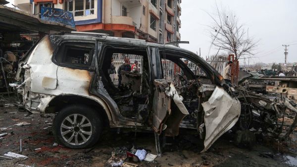 A damaged vehicle is seen at the site of a car bomb attack, in Kabul on December 20, 2020. A car bomb killed eight people and wounded more than 15 others in Kabul on December 20, officials said, the latest attack to rock the Afghan capital. Zakeria HASHIMI / AFP