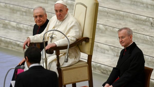Pope Francis, flanked by Monsignor Leonardo Sapienza (L) and Monsignor Luis Maria Rodrigo Ewart (R), attends an audience to deliver his Christmas greetings to the employees of the Vatican, on December 21, 2020 at Paul-VI hall at The Vatican. Vincenzo PINTO / AFP