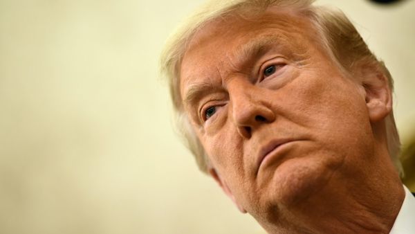 In this file photo taken on December 3, 2020 US President Donald Trump speaks before awarding the Presidential Medal of Freedom to retired football coach Lou Holtz in the Oval Office of the White House in Washington, DC. An angry backlash December 23 met US President Donald Trump's pardons of corrupt Republican congressmen and security guards convicted of killing 14 civilians in a 2007 Baghdad massacre. Trump is believed to be weighing other pardons including members of his family, his personal lawyer Rudy 