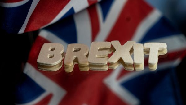 This file photograph taken on December 10, 2020, shows the flags of the United Kingdom and the European Union next to the "Brexit" word in Brussels. The 27 EU member states gave the green light on December 28, 2020, for the post-Brexit trade deal to go into effect on January 1,2021, a spokesman said. Ambassadors from EU capitals met in Brussels to nod through the accord, using a procedure which will take effect at 3:00 pm (1400 GMT) on December 29.  Kenzo TRIBOUILLARD / AFP