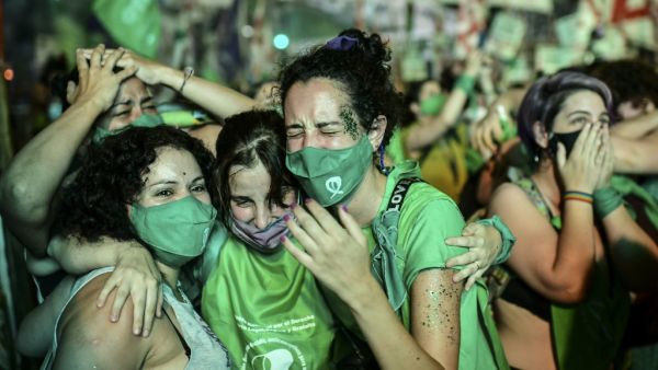 Pro-choice activists celebrate after the Senate approved a bill to legalize abortion outside the Congress in Buenos Aires on December 30, 2020. RONALDO SCHEMIDT / AFP