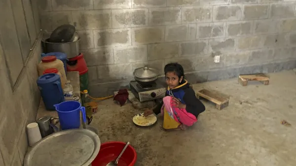 A child of Rohingya refugee eats food inside the room of a housing complex at the Bhashan Char island after they were relocated in Noakhali on December 30, 2020. Mohammad Al-MASUM MOLLA / AFP