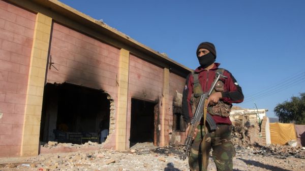 A policeman stands guard at the burnt Hindu temple a day after a mob attack in a remote village in Karak district, some 160 kms southeast of Peshawar on December 31, 2020. Hundreds of Muslims attacked and set fire to a Hindu temple in northwest Pakistan on December 30, police and witnesses said. Abdul MAJEED / AFP