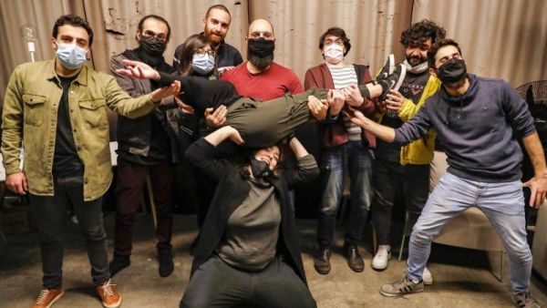 Stand-up comedians Mario Moubarak, Firas Shamieh, Mohammed Baalbaki, Nicolas Tawk, Iyad Al-Hout, Georges, and Georges pose for a picture behind Shaden (on her knees) and Lama Chmayaa (carried), in Beirut. (AFP)