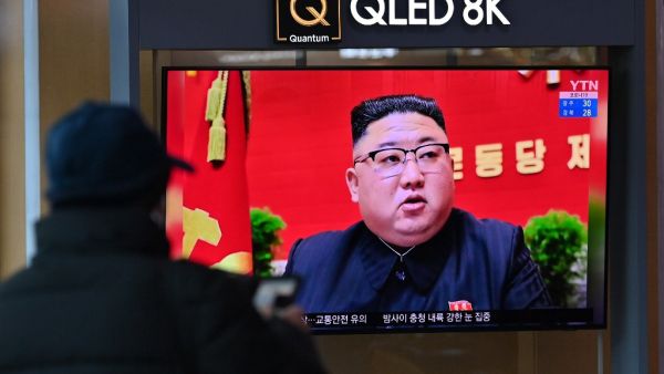 A man watches a television screen showing news footage of North Korean leader Kim Jong Un attending the 8th congress of the ruling Workers' Party held in Pyongyang, at a railway station in Seoul on January 6, 2021. Jung Yeon-je / AFP