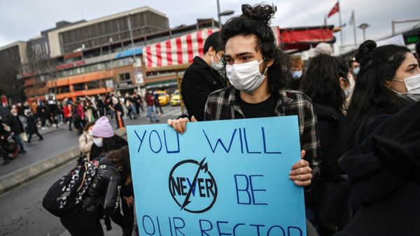 A student holds a placard as they march to Besiktis district from Bogazici university on January 6, 2021 in Istanbul during a protest against the direct appointment of the new rector to Bogazici university by Turkish President. Turkish police detained 17 people after hundreds attended a student-led protest against the appointment by the President of a rector of a top university in Istanbul.  Ozan KOSE / AFP
