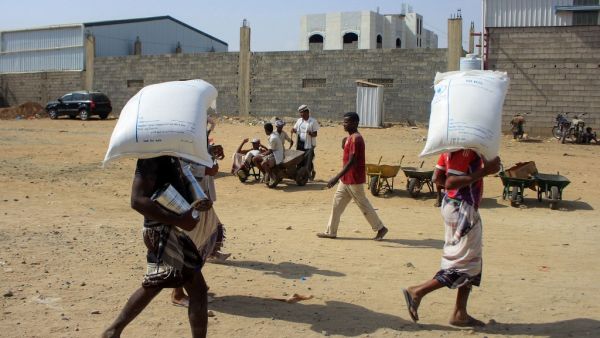 Displaced Yemenis receive humanitarian aid provided by the World Food Programme (WFP) in the northern province of Hajjah, on January 12, 2021. ESSA AHMED / AFP