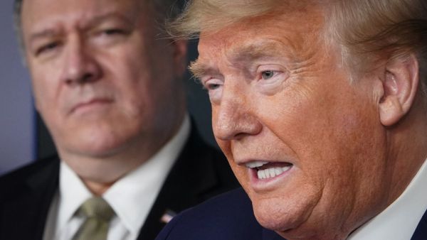 In this file photo US Secretary of States Mike Pompeo listens as US President Donald Trump speaks during the daily briefing on the novel coronavirus, Covid-19, in the Brady Briefing Room at the White House on April 8, 2020, in Washington, DC. Donald Trump in his final days in the White House has seen cabinet members quit, his vice president for the first time take a distance and some members of his party support impeachment. But he still has loyalty until the bitter end from Secretary of State Mike Pompeo. 