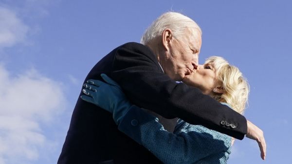 US President Joe Biden (L) kisses his wife US First Lady Jill Biden after being sworn in during his inauguration as the 46th US President on January 20, 2021, at the US Capitol in Washington, DC. Andrew Harnik / POOL / AFP
