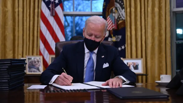 US President Joe Biden sits in the Oval Office as he signs a series of orders at the White House in Washington, DC, after being sworn in at the US Capitol on January 20, 2021. US President Joe Biden signed a raft of executive orders to launch his administration, including a decision to rejoin the Paris climate accord. The orders were aimed at reversing decisions by his predecessor, reversing the process of leaving the World Health Organization, ending the ban on entries from mostly Muslim-majority countries