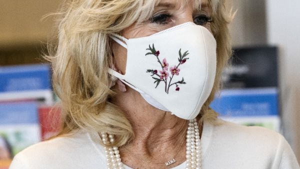First lady Jill Biden’s necklace spells "Mama" as she takes a tour of Whitman-Walker Health hospital on January 22, 2021 in Washington, DC.  Jacquelyn Martin / POOL / AFP