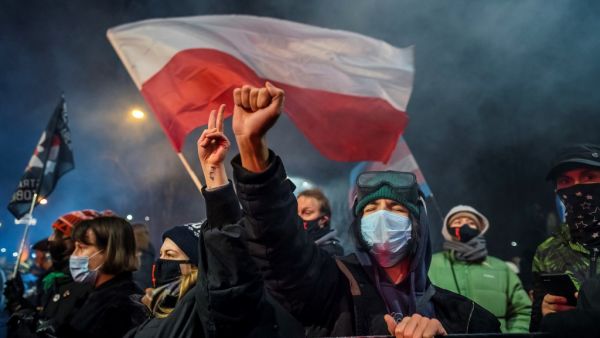 A demonstrator gestures as people take part in a pro-choice protest in the center of Warsaw, on January 27, 2021, as part of a nationwide wave of protests since October 22, 2020 against Poland's near-total ban on abortion. A demonstrator holds a banner reading "Abortion on demand" as she takes part in a pro-choice protest in the center of Warsaw, on January 27, 2021, as part of a nationwide wave of protests since October 22, 2020 against Poland's near-total ban on abortion. A controversial Polish court ruli