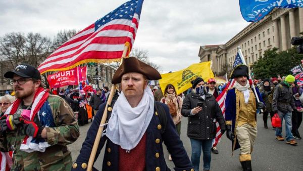 Supporters of US President Donald Trump march through the streets of the city as they make their way to the Capitol Building in Washington, on January 6, 2021. (AFP)